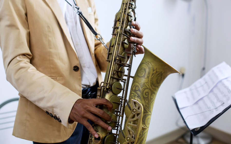 A saxophone player performing from sheet music