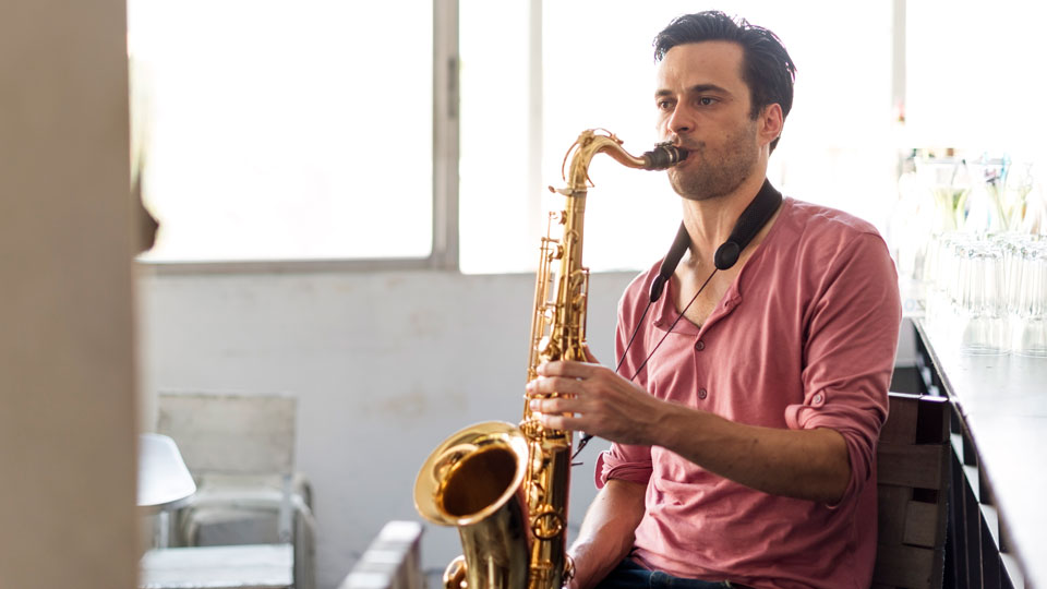 man playing a saxophone from the woodwind insrtrument family