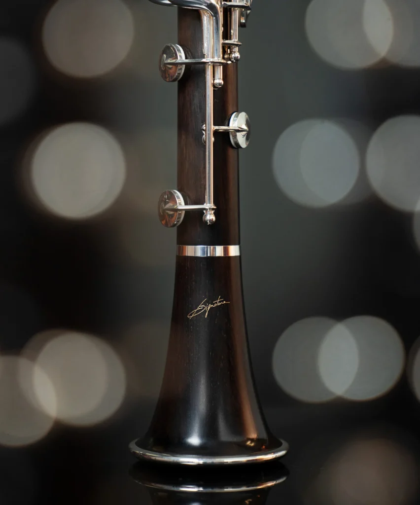 Image shows photograph of the bell with the 'signature' detailing and start of lower joint of the Selmer Signature Bb Clarinet.
