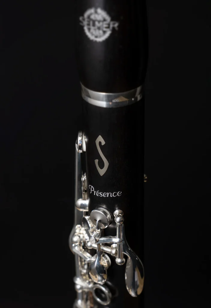 Image of Selmer Presence Clarinet close up of barrel and upper joint, engraving of 'Presence' name and iconic 'S' logo