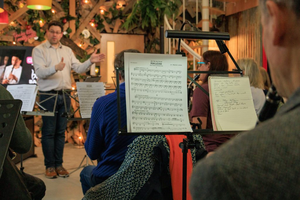 Clarinet Player, Peter Cigleris stands in front of a group of people player